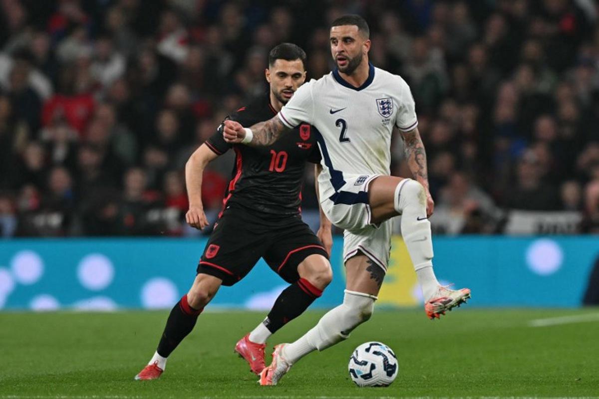 England's defender #02 Kyle Walker (R) vies with Albania's midfielder #10 Nedim Bajrami (L) during the 2026 World Cup Group K qualifier football match between England and Albania, at Wembley stadium in London, on March 21, 2025. Glyn KIRK / AFP