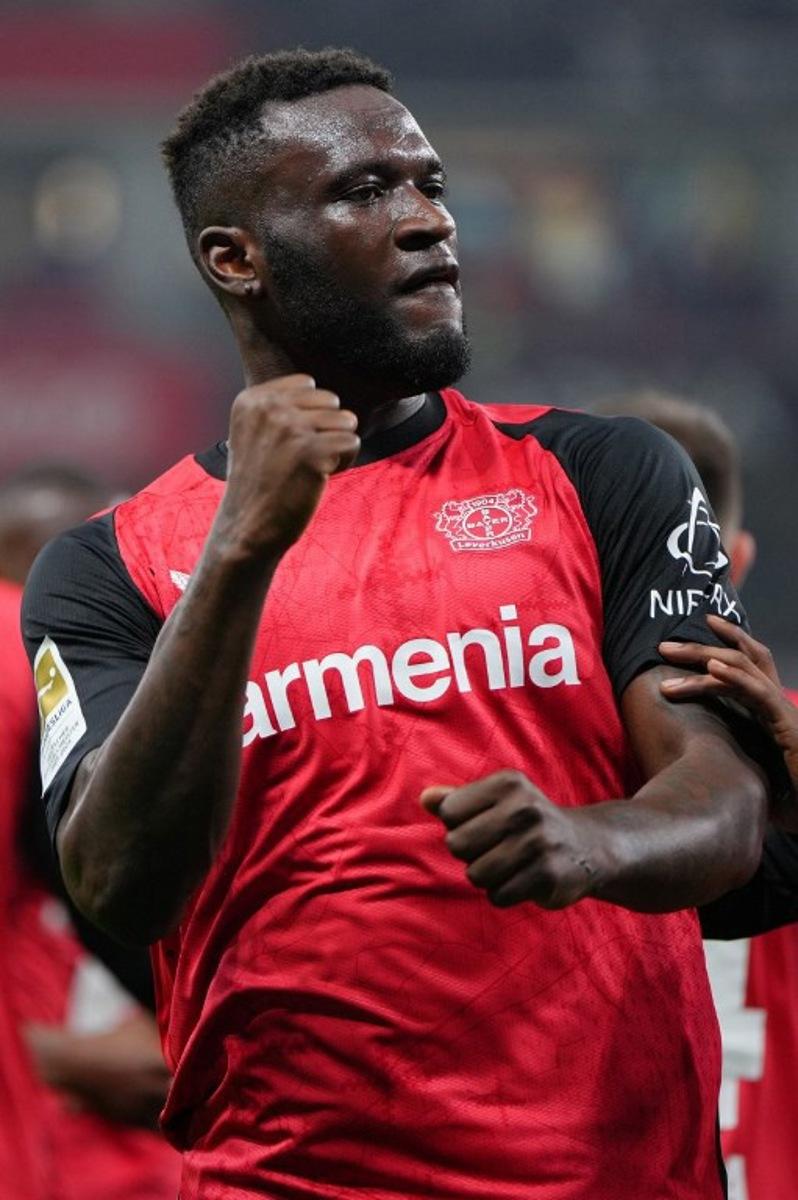 Bayer Leverkusen's Nigerian forward #22 Victor Boniface celebrates scoring the 2-1 goal with his teammates during the German first division Bundesliga football match between Bayer 04 Leverkusen and VfL Bochum in Leverkusen, western Germany on March 28, 2025. Pau BARRENA / AFP