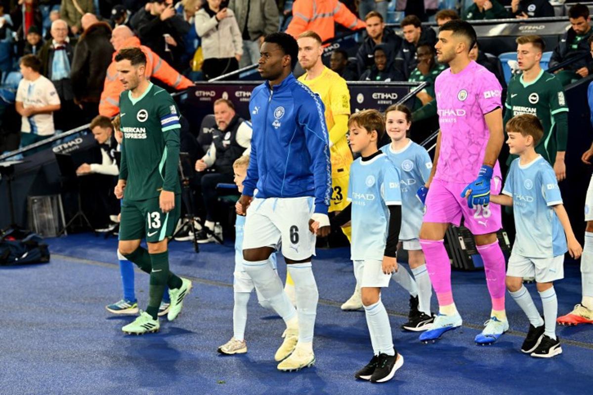 Manchester City's English defender #06 Marc Guehi leads his teammates out before the English League Cup fourth round football match between Manchester City and Brighton and Hove Albion at the Etihad stadium in Manchester, north-west England on October 28, 2026. PETER POWELL / AFP