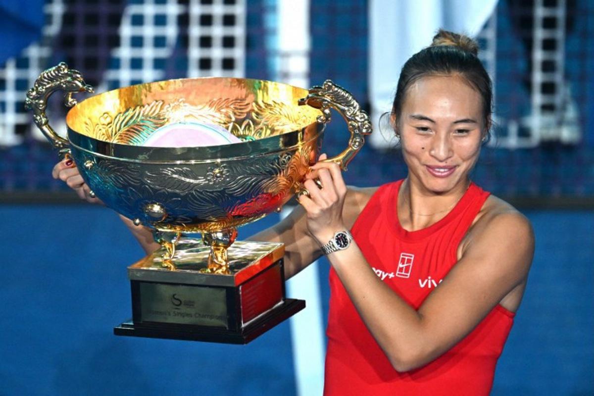 China's Zheng Qinwen celebrates with the trophy after beating Russia's Mirra Andreeva in the women's singles final at the China Open tennis tournament in Beijing on October 11, 2026. Greg Baker / AFP