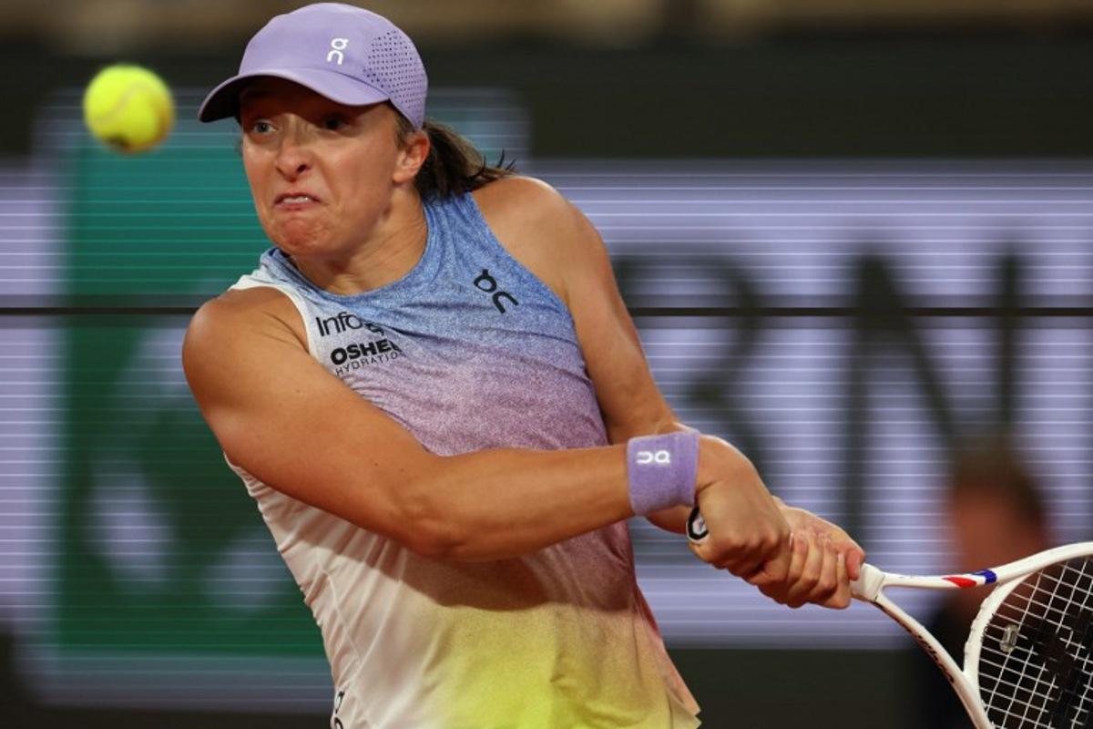 Poland's Iga Swiatek plays a backhand return to Belarus' Aryna Sabalenka during their women's singles semi-final match on day 12 of the French Open tennis tournament on Court Philippe-Chatrier at the Roland-Garros Complex in Paris on June 5, 2025. Alain JOCARD / AFP