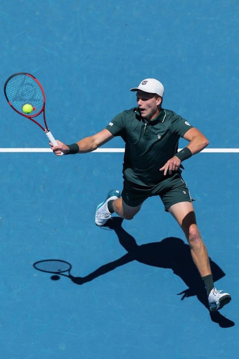USA's Jenson Brooksby hits a return against compatriot Taylor Fritz during their men's singles match on day three of the Australian Open tennis tournament in Melbourne on January 14, 2025. Adrian DENNIS / AFP