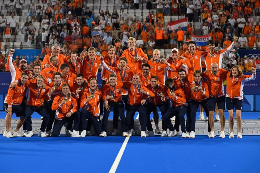 Netherlands' players pose on the podium with their gold medals after the men's final field hockey match between Germany and the Netherlands during the Paris 2024 Olympic Games at the Yves-du-Manoir Stadium in Colombes on August 8, 2024. Arun SANKAR / AFP