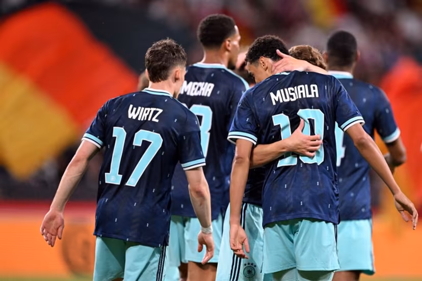 Germany's midfielder #10 Jamal Musiala (R) celebrates scoring his team's fourth goal with teammate Germany's midfielder #17 Florian Wirtz and others during a friendly match between Germany and Finland ahead of the 2026 FIFA World Cup football tournament, in Mainz, western Germany on May 31, 2026. Kirill KUDRYAVTSEV / AFP