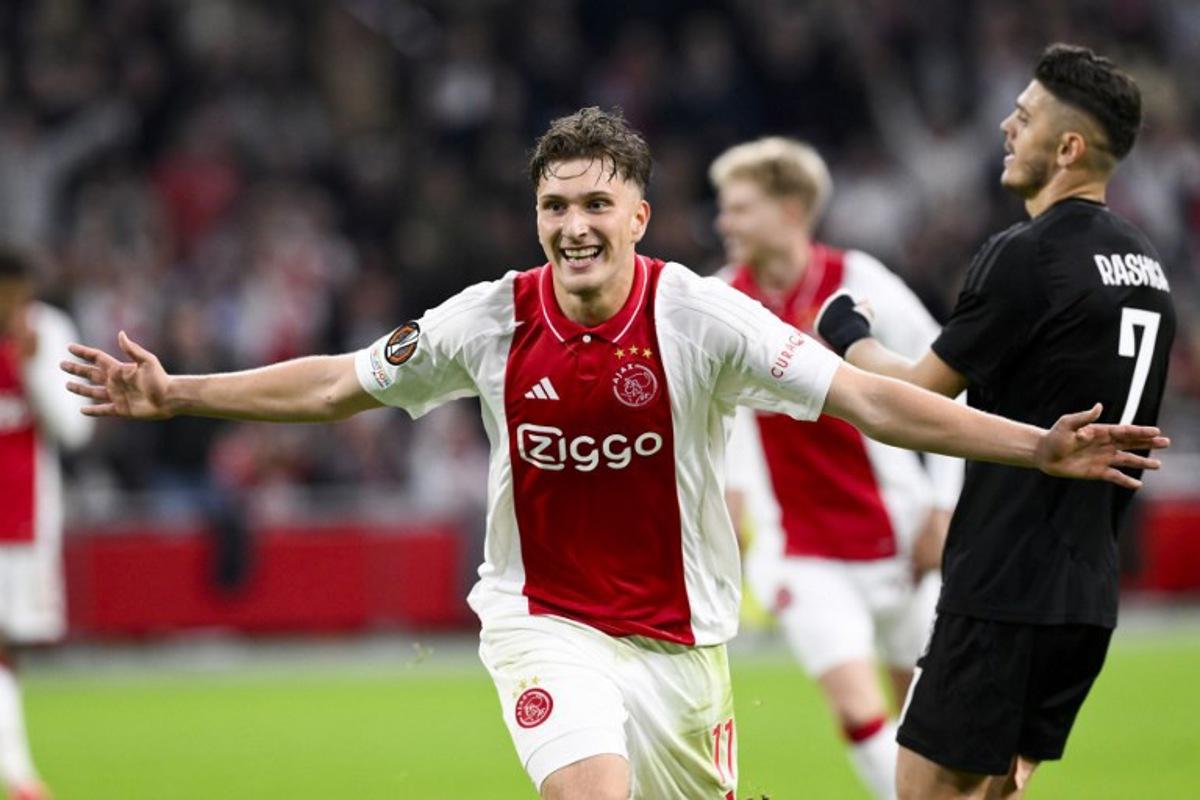 Ajax's Belgian forward #11 Mika Godts celebrates scoring his team's fourth goal during the UEFA Europa League football match between Ajax Amsterdam and Besiktas at The Johan Cruijff Arena Stadium in Amsterdam on September 26, 2024. JOHN THYS / AFP