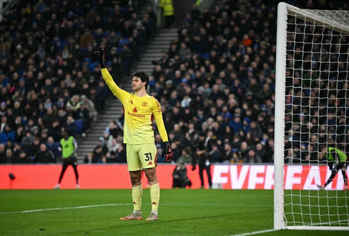 Manchester United's Belgian goalkeeper #31 Senne Lammens gestures to teammates during the English Premier League football match between Everton and Manchester United at the Hill Dickinson Stadium in Liverpool, north west England on February 23, 2026. Paul ELLIS / AFP