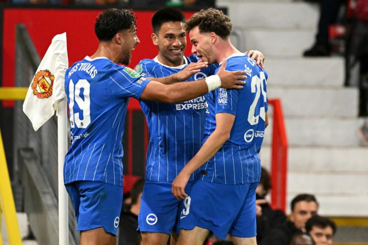 Brighton's Belgian defender #29 Maxim De Cuyper (R) celebrates scoring the team's third goal during the English League Cup third round football match between Manchester United and Brighton and Hove Albion at Old Trafford in Manchester, north west England, on September 16, 2026. Oli SCARFF / AFP
