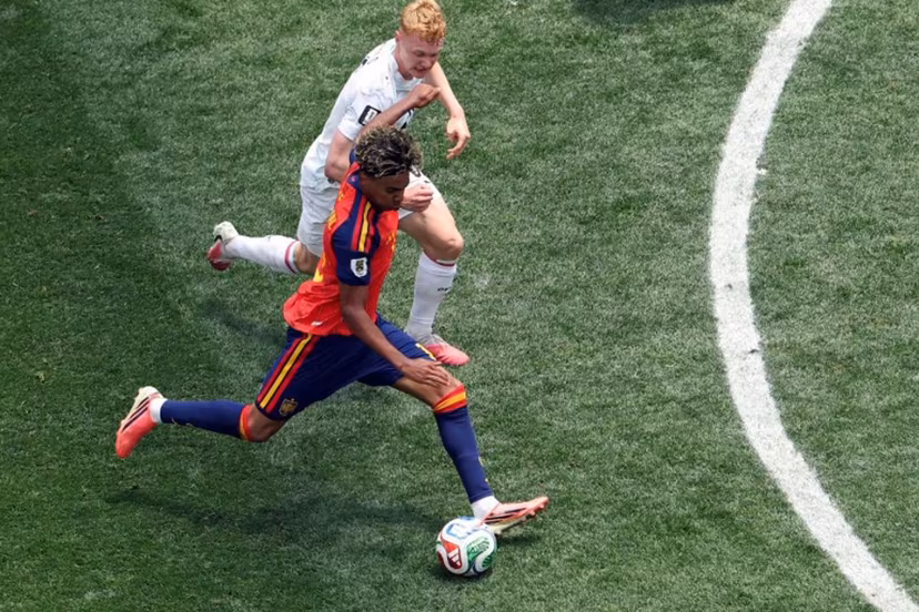 Spain's forward #19 Lamine Yamal (bottom) kicks the ball past Austria's midfielder #06 Nicolas Seiwald during the 2026 World Cup round of 32 football match between Spain and Austria at the Los Angeles Stadium in Inglewood on July 2, 2026. VALERIE MACON / AFP