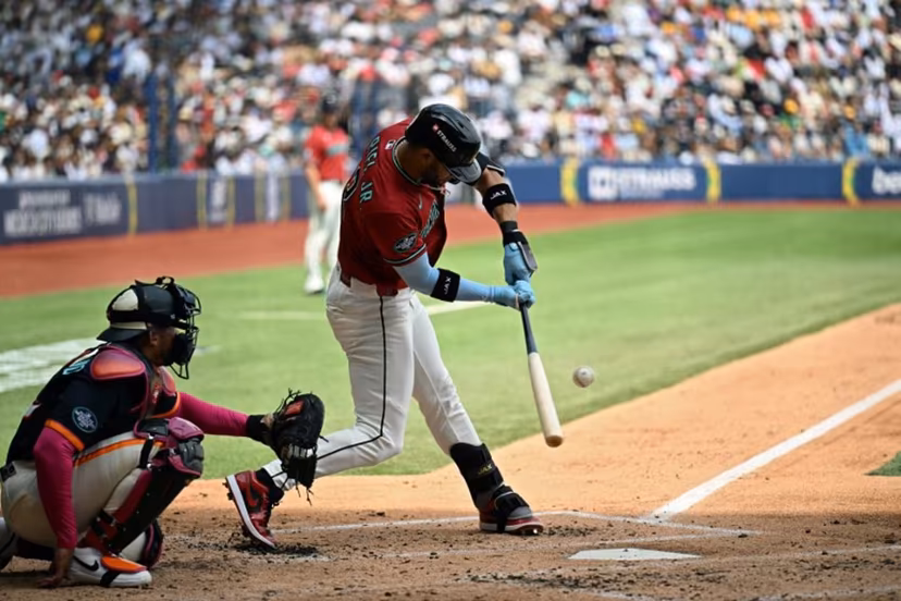 Arizona Diamondbacks' #12 Lourdes Gurriel Jr. swings in front of San Diego Padres' #12 Luis Campusano during the MLB World Tour Mexico City Series game between the Arizona Diamondbacks and the San Diego Padres at Alfredo Harp Helu Stadium in Mexico City on April 26, 2026. YURI CORTEZ / AFP