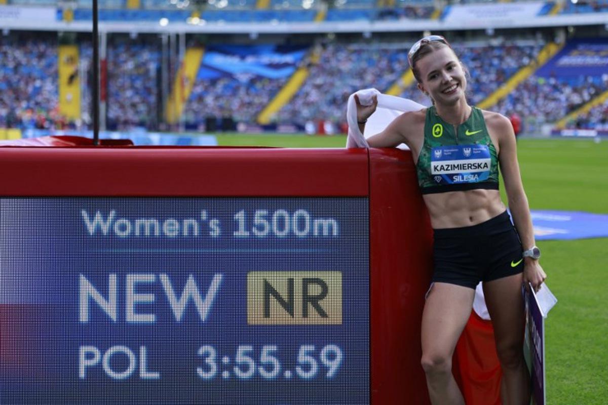 Poland's Klaudia Kazimierska celebrates by the new Polish record banner after placing fourth in the 1500 m event of the Silesia Diamond League athletics meeting in Katowice, Poland, on August 23, 2026. Wojtek RADWANSKI / AFP