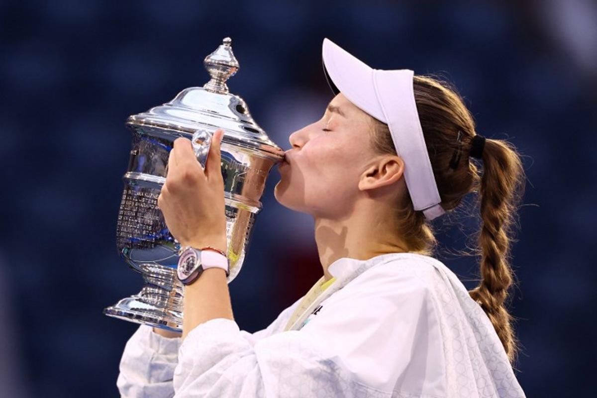 Kazakhstan's Elena Rybakina kisses the winner's trophy after winning the women's singles final tennis match against Belarus's Aryna Sabalenka on day fourteen of the US Open tennis tournament at the USTA Billie Jean King National Tennis Center in New York City on September 12, 2026. CHARLY TRIBALLEAU / AFP