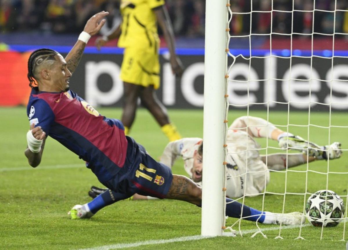 Barcelona's Brazilian forward #11 Raphinha scores the opening goal during the UEFA Champions League Quarter final First Leg football match between FC Barcelona and BVB Borussia Dortmund at the Estadi Olimpic Lluis Companys in Barcelona on April 9, 2025. Josep LAGO / AFP