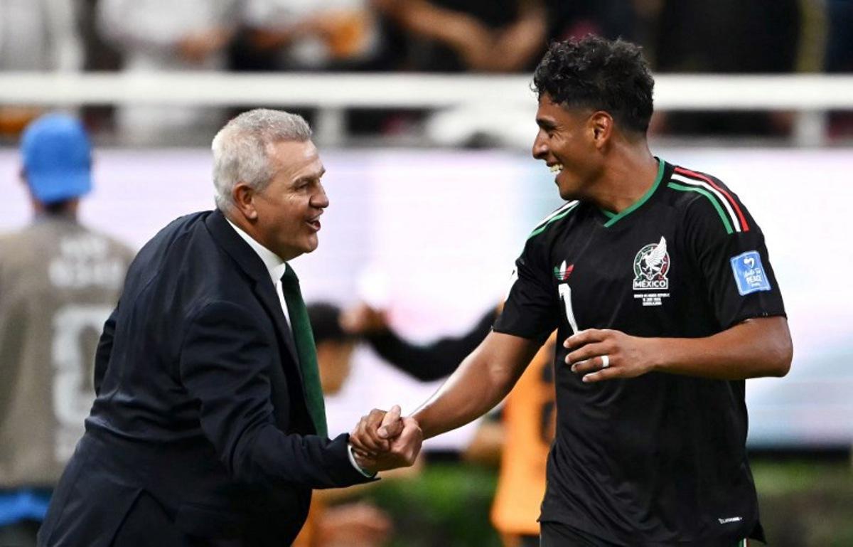 Mexico's midfielder #07 Luis Romo celebrates with head coach Javier Aguirre scoring his team's first goal during the 2026 World Cup Group A football match between Mexico and South Korea at the Guadalajara Stadium in Zapopan on June 18, 2026. CARL DE SOUZA / AFP