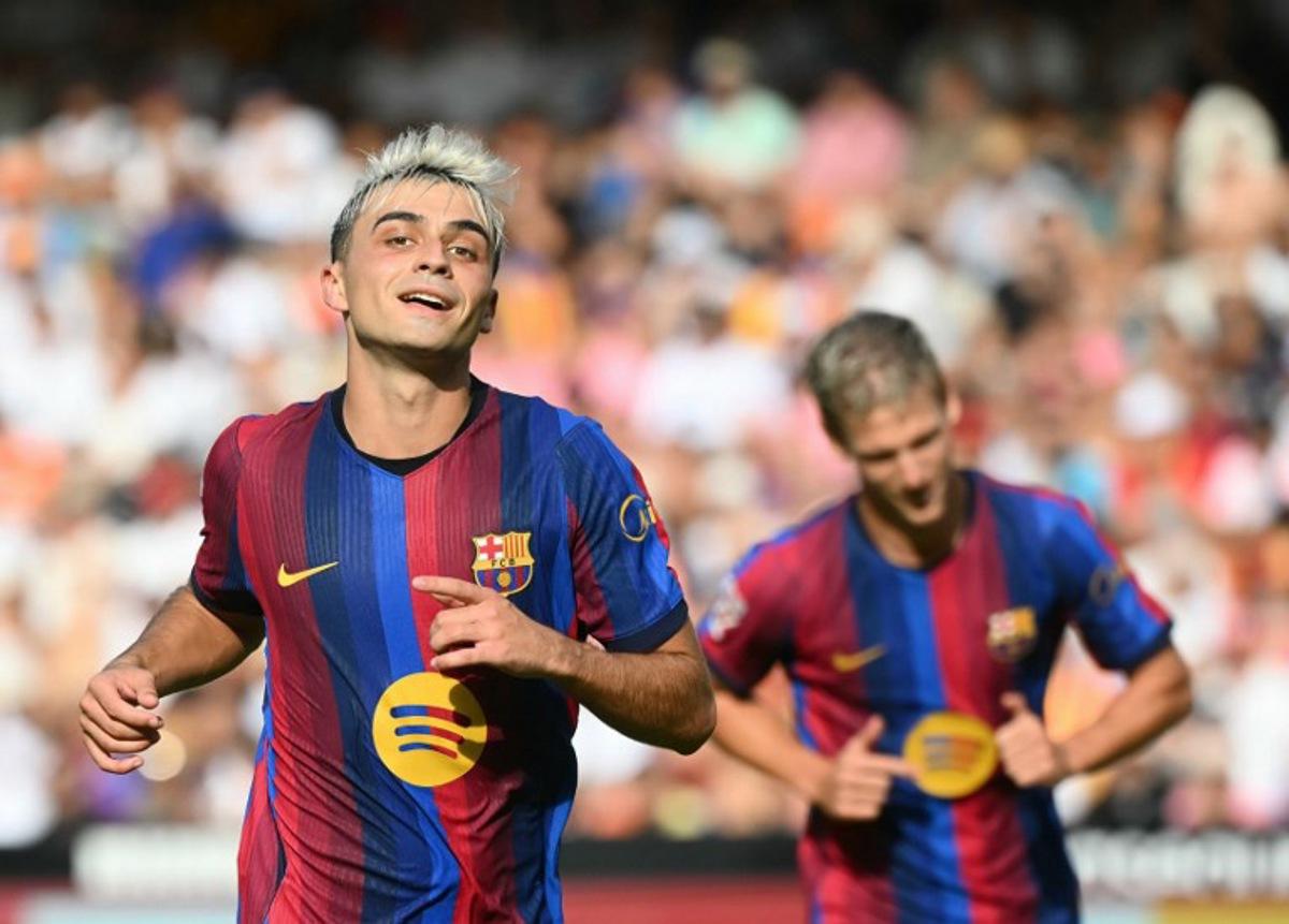 Barcelona's Spanish midfielder #08 Pedri celebrates with teammates scoring his team's fourth goal during the Spanish league football match between Valencia CF and FC Barcelona at Mestalla Stadium in Valencia on September 6, 2026. JOSE JORDAN / AFP