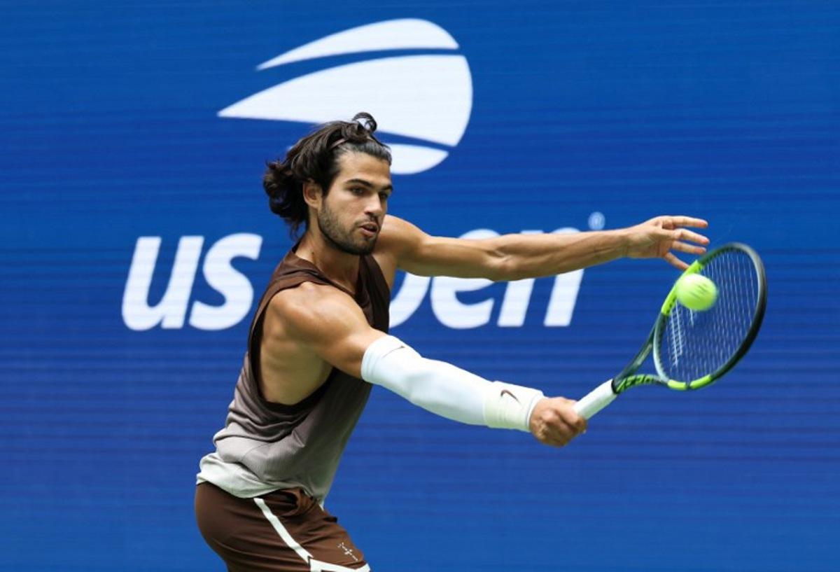Spain's Carlos Alcaraz hits a return to Russia's Roman Safiullin during their men's singles first round tennis match on day two of the US Open tennis tournament at the USTA Billie Jean King National Tennis Center in New York City on August 31, 2026. TIMOTHY A. CLARY / AFP