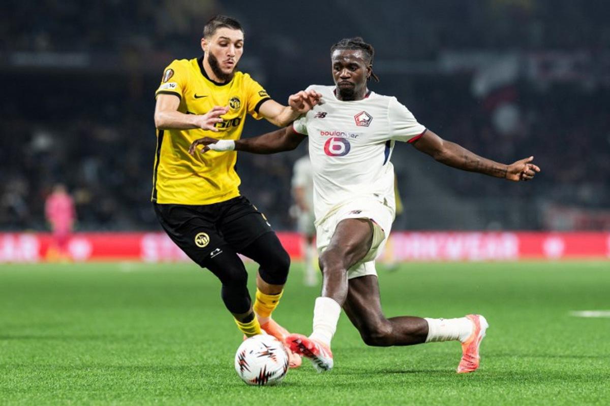 Young Boys' Algerian defender #3 Jaouen Hadjam (L) fights for the ball with Lille's Congolese midfielder #17 Ngal'Ayel Mukau (R) during the UEFA Europa League, league phase, football match between Young Boys and Lille LOSC at the Wankdorf stadium, in Bern, on December 11, 2025. ENNIO LEANZA / AFP