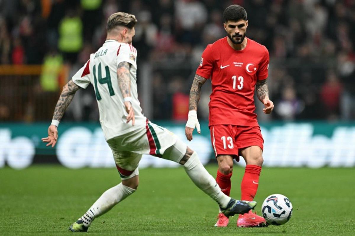 Hungary's defender #14 Bendeguz Bolla fights for the ball with Turkey's defender #13 Eren Elmali during the UEFA Nations League playoff first-leg football match between Turkey and Hungary at the Rams Park Ali Samiyen Sport Complex Stadium in Istanbul on March 20, 2025. OZAN KOSE / AFP