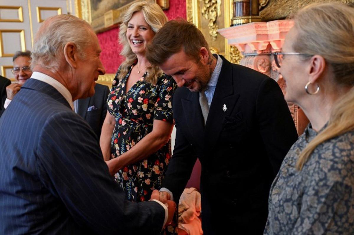 English former football player David Beckham (C) shakes hands with Britain's King Charles III (front L) during the King's Foundation Awards ceremony, on the 35th anniversary of The King's Foundation, at St James's Palace, in London, on June 12, 2025. Chris J RATCLIFFE / POOL / AFP