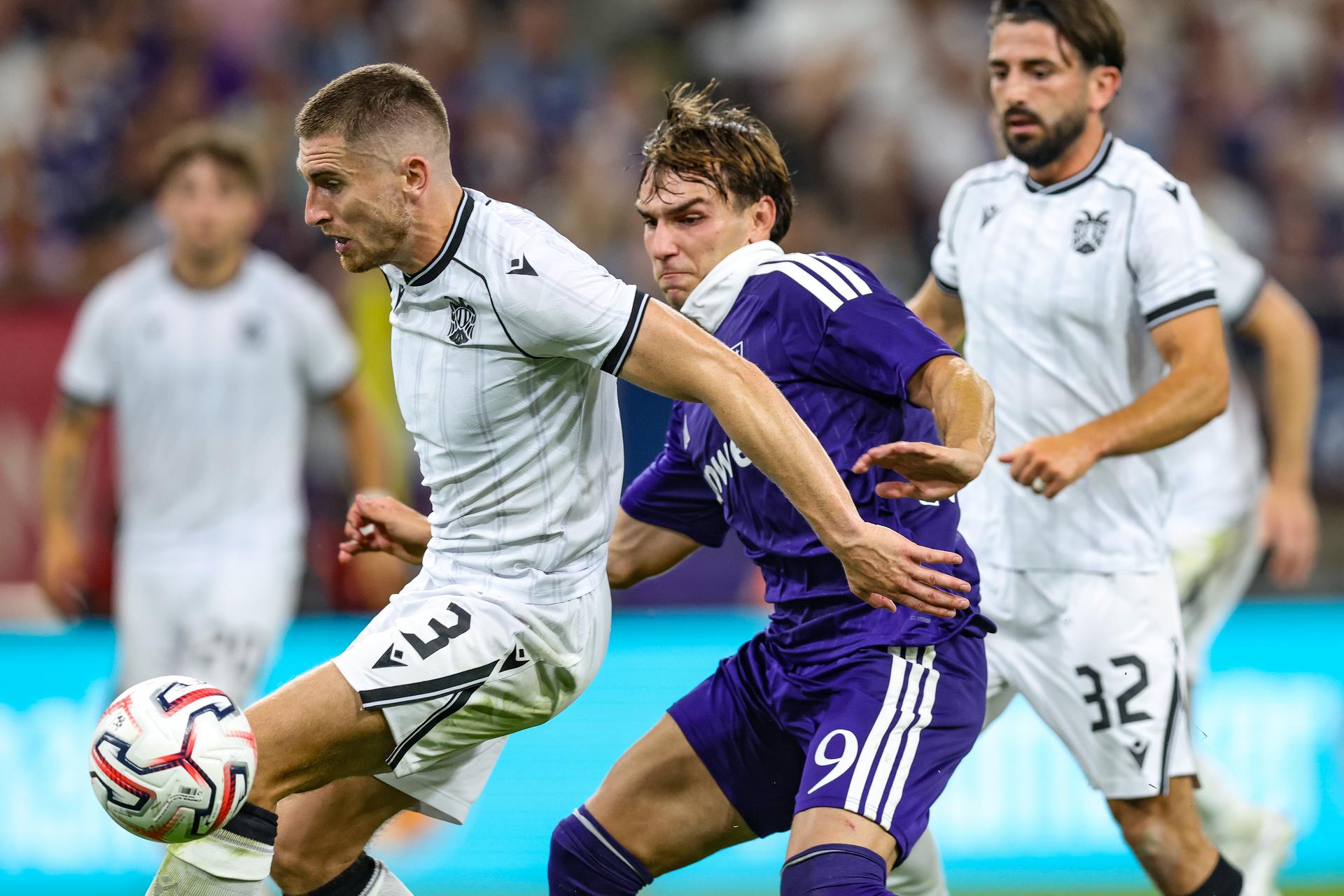 PAOK's Jonjoe Kenny and Anderlecht's Mihajlo Cvetkovic fight for the ball during a game between Belgian RSC Anderlecht and Greek club PAOK , in Anderlecht, Brussels, Belgium, on Thursday 13 August 2026, a return leg game in the third qualifying round of the UEFA Europa League competition. RSCA won 0-1 the first leg. BELGA PHOTO BRUNO FAHY