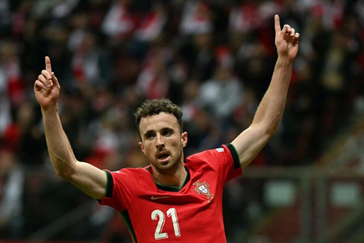 Portugal's forward #21 Diogo Jota reacts after Poland's defender #05 Jan Bednarek scored an own goal during the UEFA Nations League, League A Group A1 football match Poland vs Portugal at the National Stadium in Warsaw, Poland on October 12, 2024. Sergei GAPON / AFP