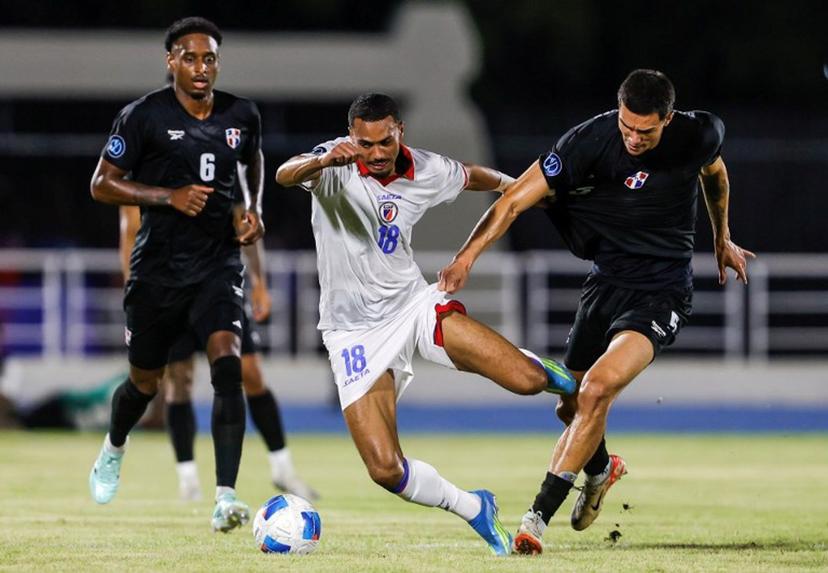 Haiti's forward #18 Wilson Isidor and Dominican Republic's defender #05 Noah Dollenmayer fight for the ball during the Concacaf Nations League Cup football match between Dominican Republic and Haiti at the Felix Sanchez Olympic Stadium in Santo Domingo on October 1, 2026. Nelson PULIDO / AFP