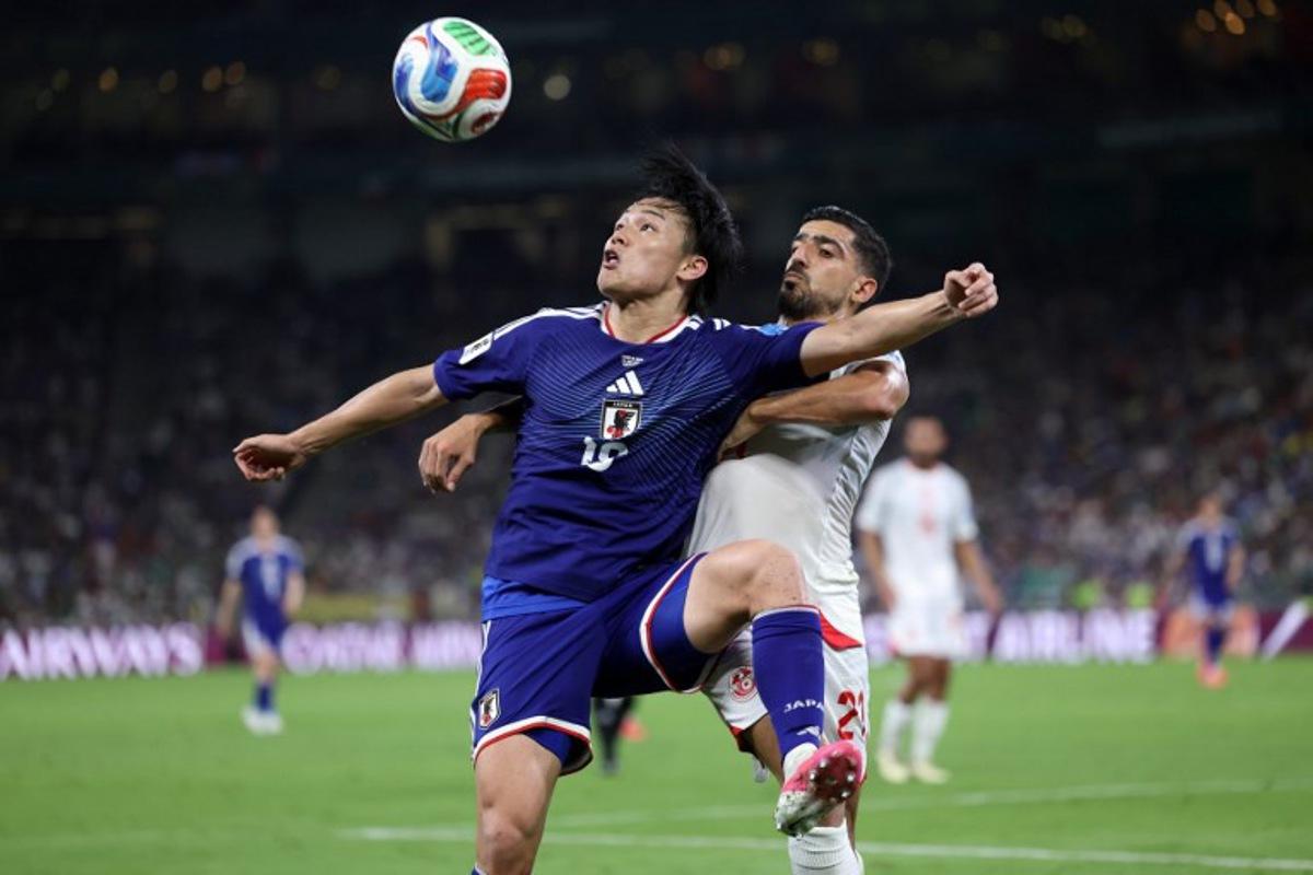 Japan's forward #18 Ayase Ueda and Tunisia's defender #21 Mohamed Ben Hamida fight for the ball during the 2026 World Cup Group F football match between Tunisia and Japan at the Monterrey Stadium in Guadalupe, Mexico, on June 20, 2026. Julio Cesar AGUILAR / AFP