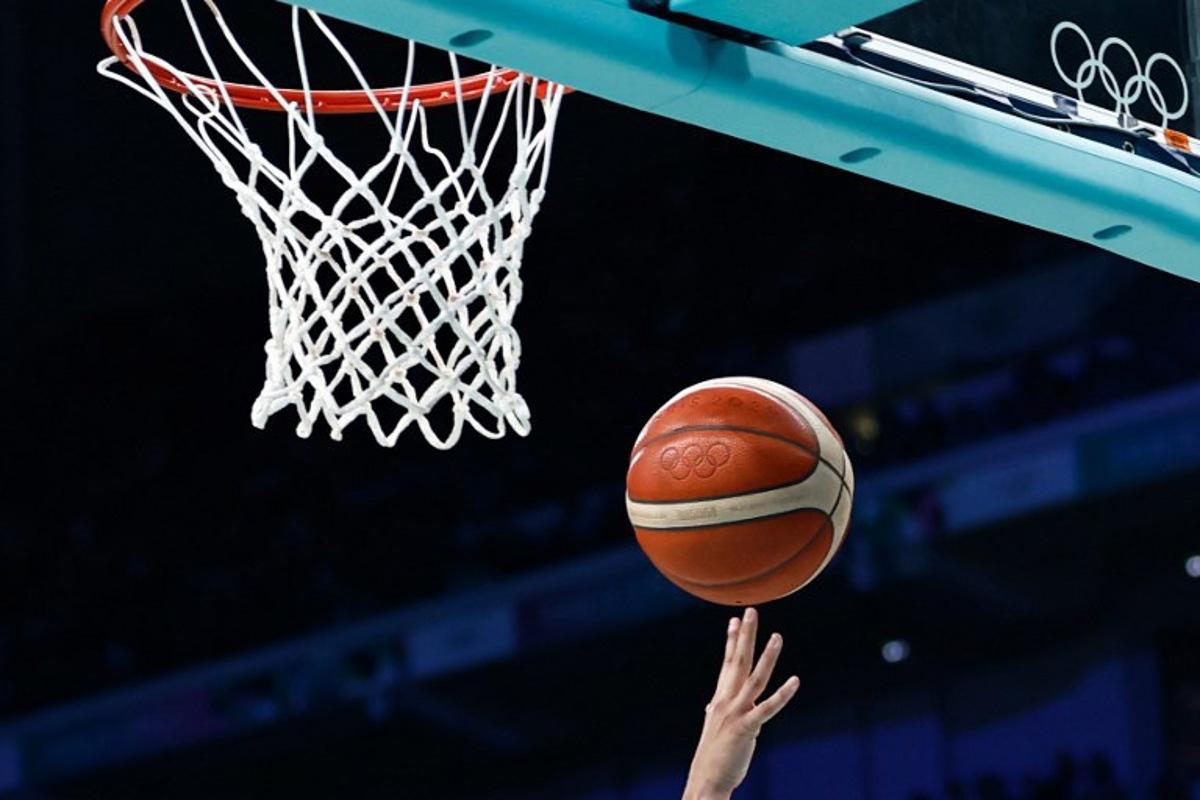 Spain's #12 Maite Cazorla goes to the basket and scores in the women's preliminary round group A basketball match between Serbia and Spain during the Paris 2024 Olympic Games at the Pierre-Mauroy stadium in Villeneuve-d'Ascq, northern France, on August 3, 2024. Sameer Al-Doumy / AFP