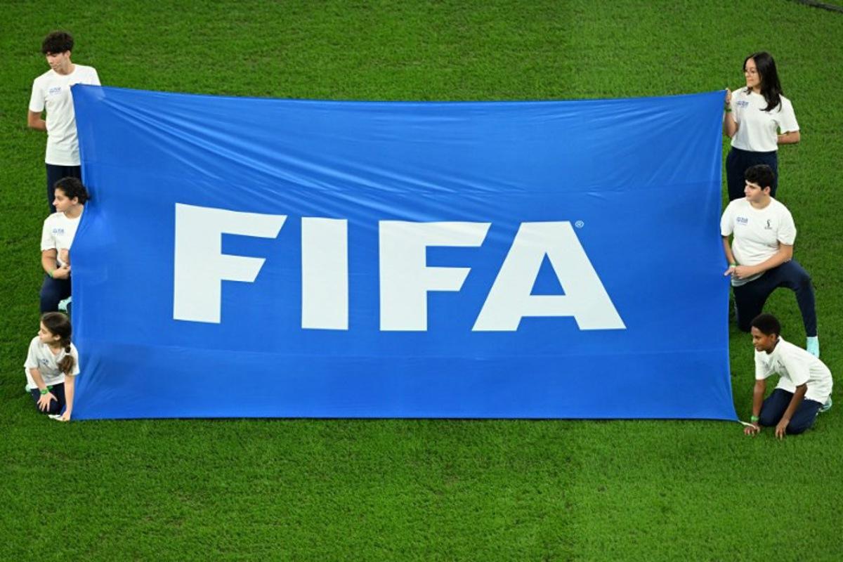 Volunteers display a FIFA banner before the start of the Qatar 2022 World Cup quarter-final football match between Croatia and Brazil at Education City Stadium in Al-Rayyan, west of Doha, on December 9, 2022. Ina Fassbender / AFP