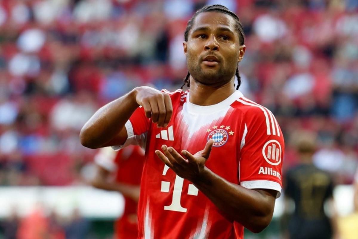 Bayern Munich's German forward #07 Serge Gnabry celebrates scoring the opening goal with his teammates during the German first division Bundesliga football match between FC Augsburg and FC Bayern Munich in Augsburg, southern Germany, on August 30, 2025. Michaela STACHE / AFP