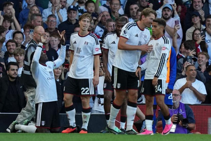 Fulham's players celebrate their first goal, an own-goal scored by Manchester United's Argentinian defender #06 Lisandro Martinez during the English Premier League football match between Fulham and Manchester United at Craven Cottage in London on September 20, 2026. CARLOS JASSO / AFP