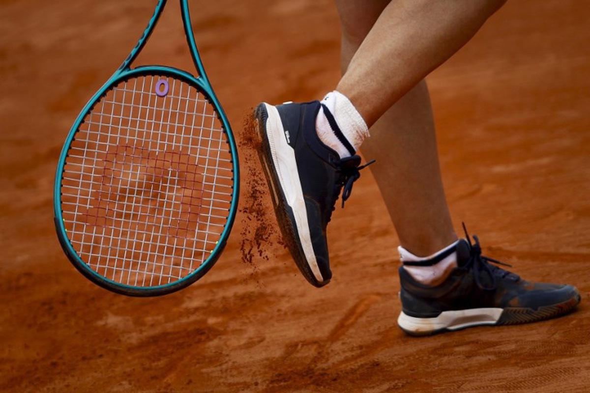 France's Leolia Jeanjean taps her shoe with her racket during her women's singles match against Romania's Elena Ruxandra Bertea at the Billie Jean King Cup play-offs between France and Romania, at Oeiras on the outskirts of Lisbon, on April 9, 2026. FILIPE AMORIM / AFP