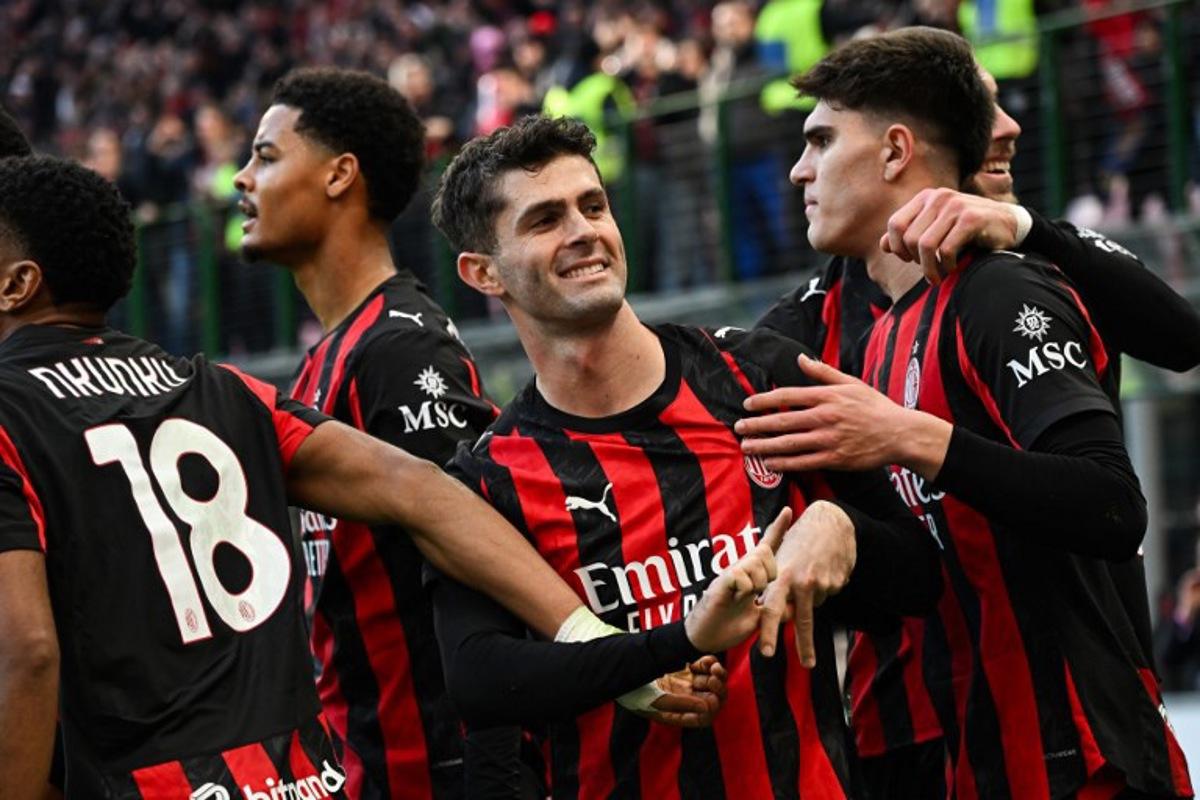 AC Milan's US forward #11 Christian Pulisic (C) celebrates after scoring his team's first goal during the Italian Serie A football match between AC Milan and Hellas Verona at the San Siro stadium in Milan, northern Italy, on December 28, 2025. Piero CRUCIATTI / AFP